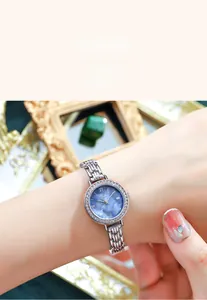 Close-up of Gedi fashion watch with silver mesh band and blue dial on model's wrist