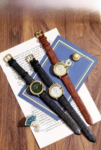 Detailed view of luxury quartz watches with leather straps and vintage gold cases