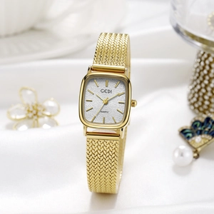 Elegant gold square quartz watch for women with mesh band on white silk background