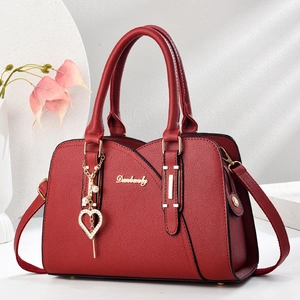 Elegant red litchi texture handbag with gold hardware and pearl heart charm for women