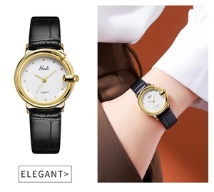 Detail of elegant gold quartz watch with black leather strap and textured white dial