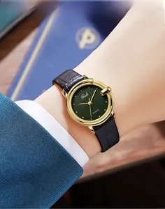 Elegant vintage lady quartz watch with green plaid dial and black leather strap worn on wrist