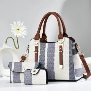 Detailed set of three woven tote bags in grey and white with brown leather accents