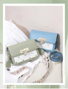 Detail showing mint green and blue mini bags with crystal heart buckles and dual straps