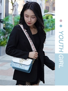 Blue sequin crossbody bag with embroidery strap and pearl charm on street model