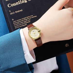 Elegant women quartz watch with gold round case, brown leather strap, and textured dial