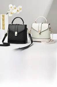Detail of elegant PU leather handbags with woven texture in black and creamy white