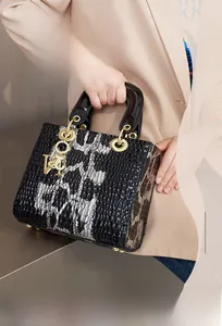 Makro-Detailansicht der glänzenden Handtasche mit Tiermuster und Goldbeschlägen