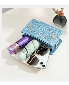 Close-up of blue sequin crossbody bag showing capacity for phone, umbrella and cosmetics