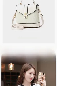 Detail of cream white handbag featuring woven texture, smooth leather and metal lock