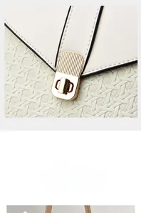 Close-up of elephant grey bag with woven texture and gold metal twist lock buckle detail
