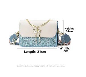 Detail view of macaron small square bag with cat pearl hardware and wide strap 21x8x14cm