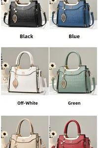 Detail of elegant crocodile-pattern leather handbags featuring unique leaf metal pendants