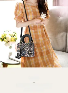Detail of ethnic geometric canvas crossbody bag with MICE tag shown in a lifestyle setting