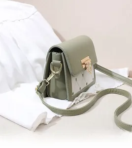 Detail of green leather bag featuring heart diamond clasp and quilted diamond patterns