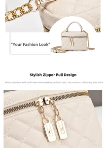 Detail der cremefarbenen Stepptasche mit vergoldetem Reißverschluss und Ledertextur