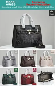 Detail view of crocodile pattern leather handbag with lock and detachable shoulder strap