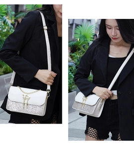 Detailed view of a white crossbody bag with silver sequins and pearl cat ear charms