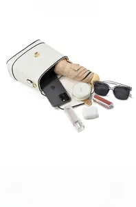Spacious interior of white bucket bag showing daily essentials like phone and umbrella