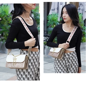 Detail of sequin crossbody bag featuring a cat pearl pendant and ethnic wide shoulder strap