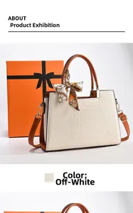 Detail of off-white crocodile embossed tote bag with printed silk scarf and brown handle