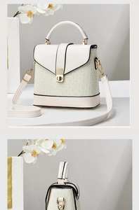 Detail of white structured bag featuring woven texture, gold metal lock and top handle