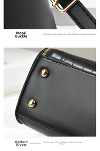 Detailed view of durable golden metal hardware and wear-resistant rivets on black leather bag