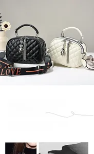 Detail of quilted leather bag with cute bear pendant and LOVE letter wide strap