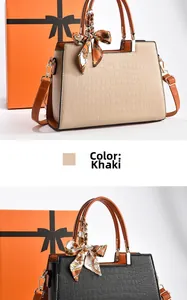 Detail of khaki and black crocodile embossed tote bags with orange handles and silk scarves