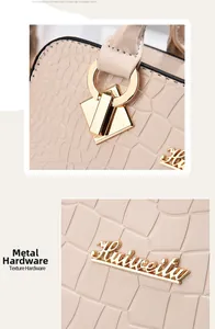 Detail einer beige Kunstleder Handtasche mit Krokodilmuster und goldener Metall Hardware