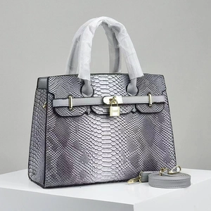Elegant grey python-textured leather handbag with golden padlock and detachable strap