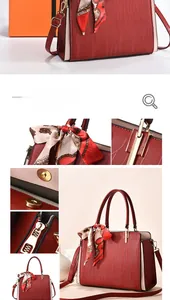 Macro detail of red textured handbag with gold zipper, silk scarf and contrast side panels