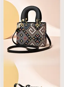 Back view of a woven handbag with colorful geometric patterns and black faux leather straps