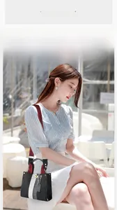 Romantic style canvas bag with red strap shown in a sunny outdoor cafe setting