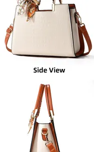 Detail view of cream crocodile texture tote bag with brown handles and decorative silk scarf