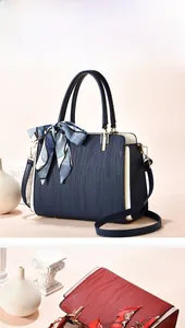 Detail of elegant textured leather tote bags with printed silk scarf and metallic rivets