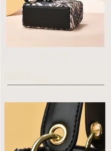 Detail of woven fabric texture and gold round buckle on small crossbody handbag