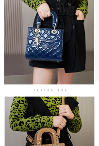 Detailed view of quilted faux leather handbags with iconic metal charms and round handles
