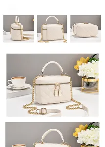 Detail der cremeweißen gesteppten Koffer-Tasche mit Goldkette und Doppel-Reißverschluss