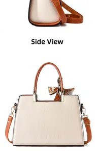Detail view of cream crocodile-embossed leather tote with silk scarf and gold hardware