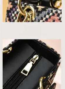 Detailed macro view of tweed weave fabric and golden metal ring hardware on handbag