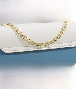 Detail of color-block leather handbag with premium gold metal chain and stitching