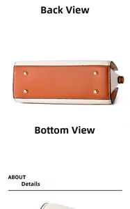 Detail view of the handbag bottom featuring color-block leather and gold metal feet studs