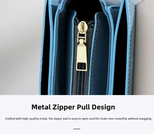 Detail of light blue leather bag featuring a smooth gold-tone metal zipper and precise stitching