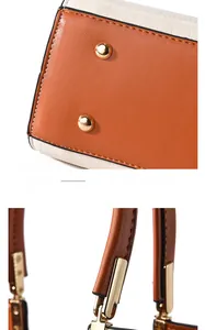 Detail of protective gold rivets on the bottom and metal hardware of the leather handbag