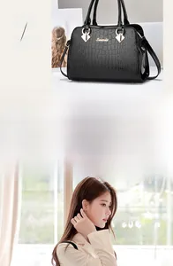 Detailansicht der schwarzen Handtasche mit Steinmuster, Goldbeschlägen und Trapezform