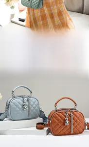 Detailed quilted texture on handbags featuring a metal bear charm and lettered straps