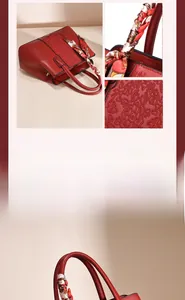 Close-up of fine floral embroidery and silk scarf handle on dark red handbag