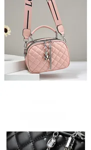 Close-up of quilted rhombic pattern on leather handbag with trendy wide logo strap