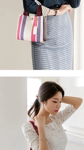 Detailed view of striped office tote with golden metal clasp and woven handles